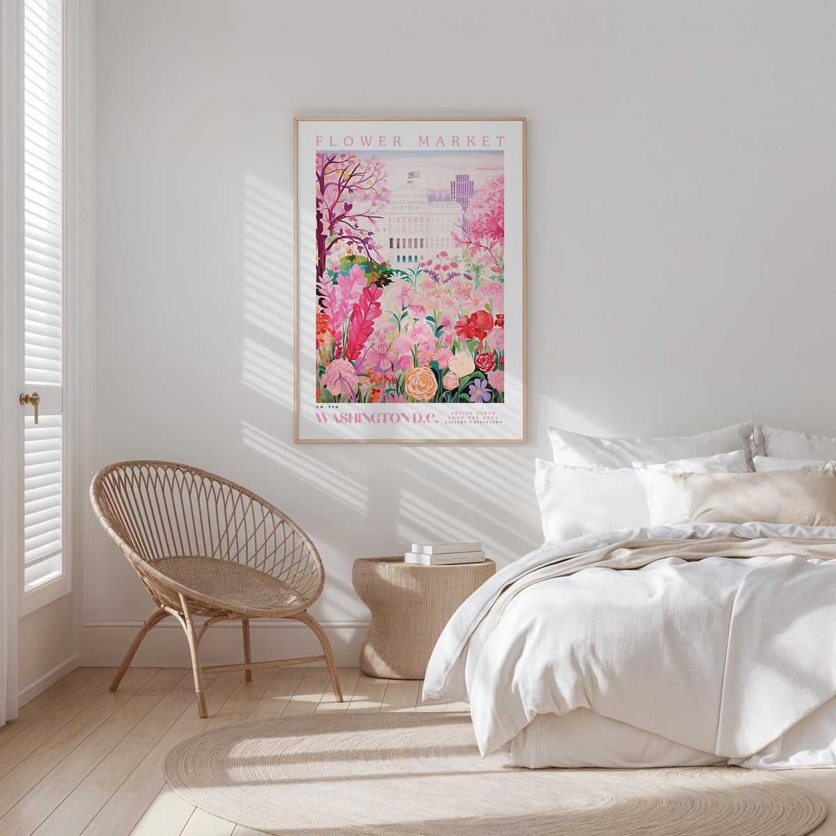 a bedroom with a bed, a woven chair, and a framed poster of a flower market on the wall.