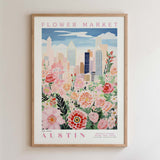 The image is a framed poster depicting a cityscape with a flower market in the background.