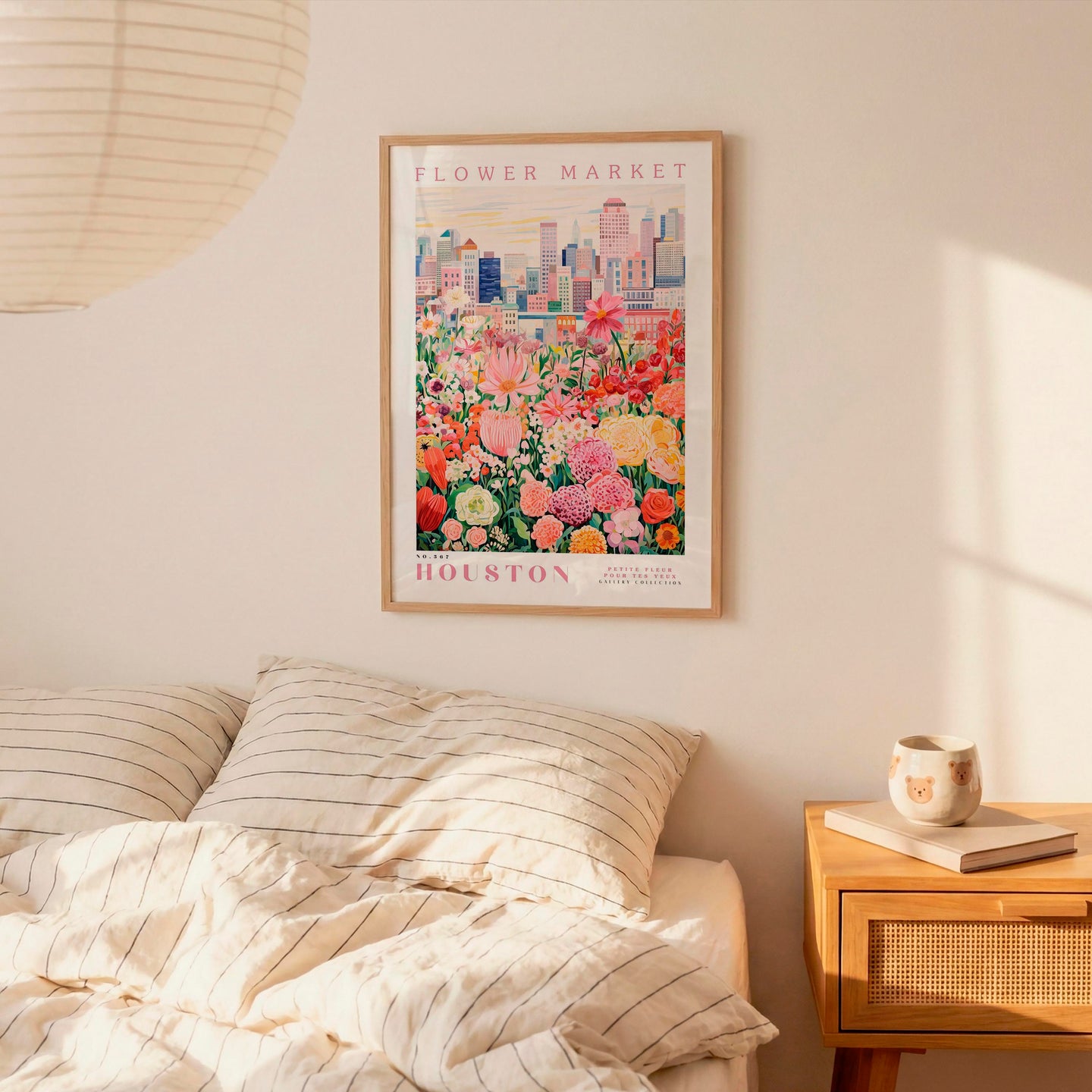 a bedroom with a bed, a nightstand, and a framed poster of a flower market in Houston hanging on the wall.