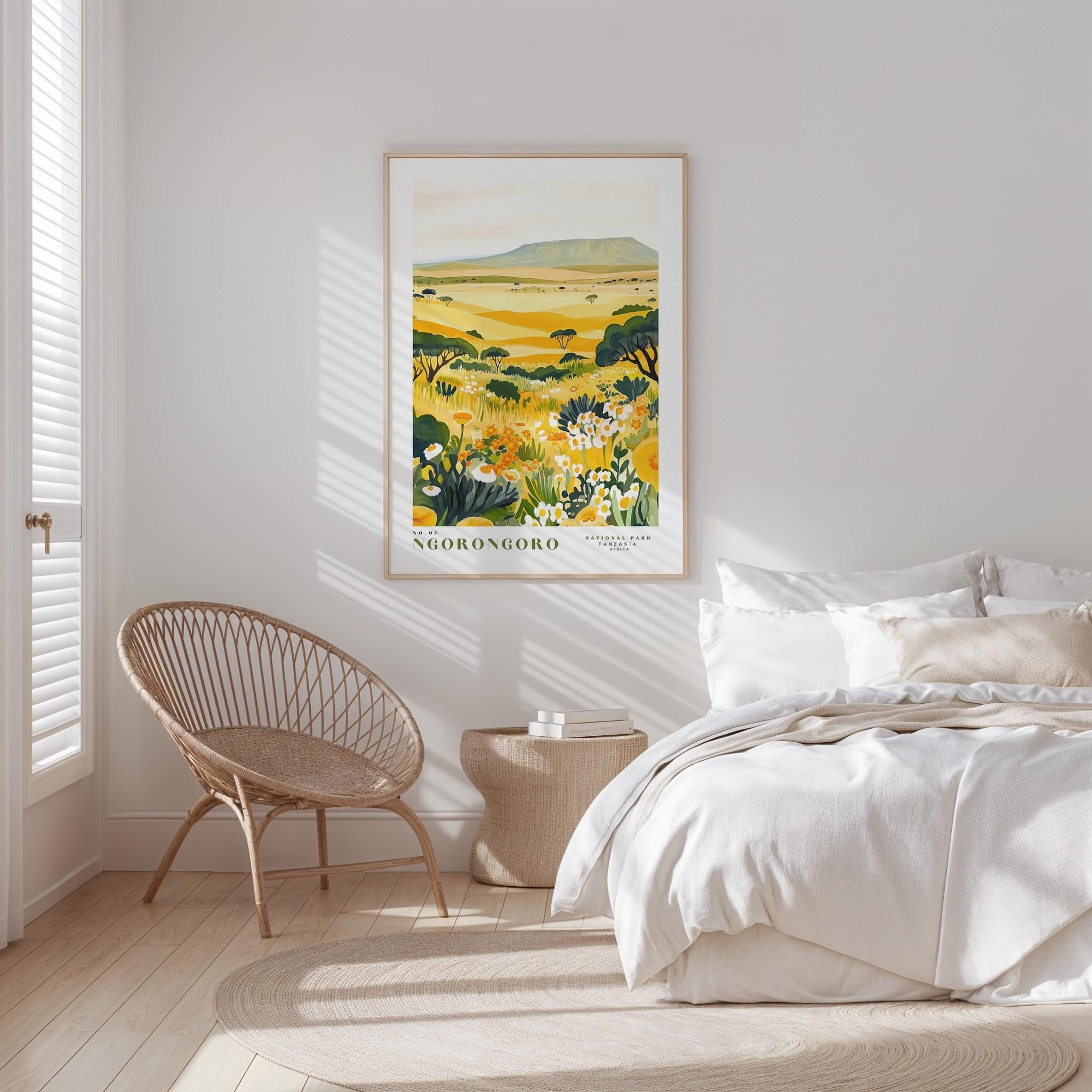 a serene bedroom scene with a large bed, a woven chair, and a framed print of a landscape with yellow flowers and green foliage.
