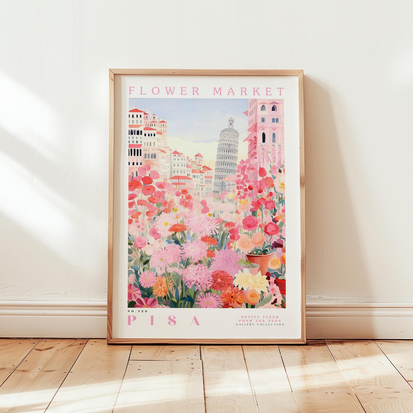 A framed poster depicting a vibrant and colorful flower market in Pisa, Italy, with the Leaning Tower of Pisa in the background.