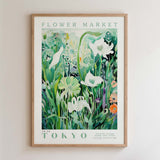 The image is a framed poster depicting a lush, green garden with various flowers and plants.