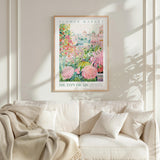 a framed poster of a flower market, with a white sofa and a plant in the foreground.
