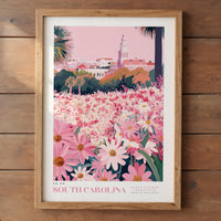 A framed poster depicting a vibrant field of pink and white flowers, with a tall tower in the background, likely representing the State Flower of South Carolina.