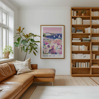 a cozy living room with a large bookshelf filled with books, a comfortable leather sofa, and a framed poster of a scenic view of Rhode Island.