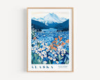 A framed poster depicting a scenic landscape with a mountain range, a lake, and a field of colorful wildflowers.