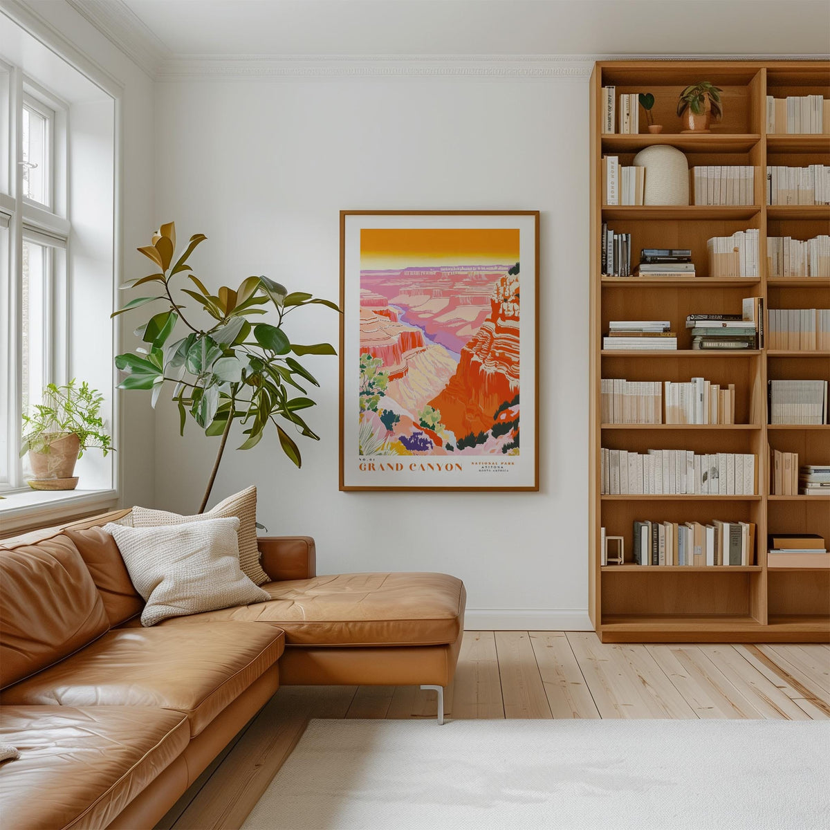 a cozy living room with a large window, a comfortable leather sofa, a wooden bookshelf filled with books, and a framed poster of the Grand Canyon hanging on the wall.