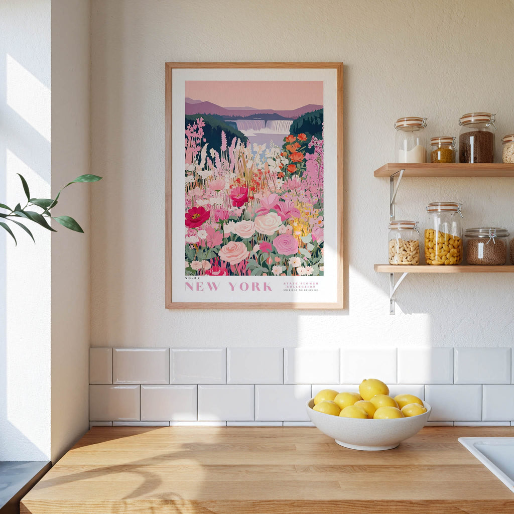 a kitchen scene with a framed poster of a colorful garden hanging on the wall above a wooden countertop with a bowl of lemons.