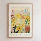 The image is a framed poster depicting a cityscape with a field of colorful flowers in the foreground.
