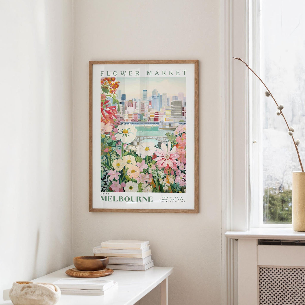 a framed poster of a cityscape with a flower market in Melbourne, Australia, hanging on a wall.