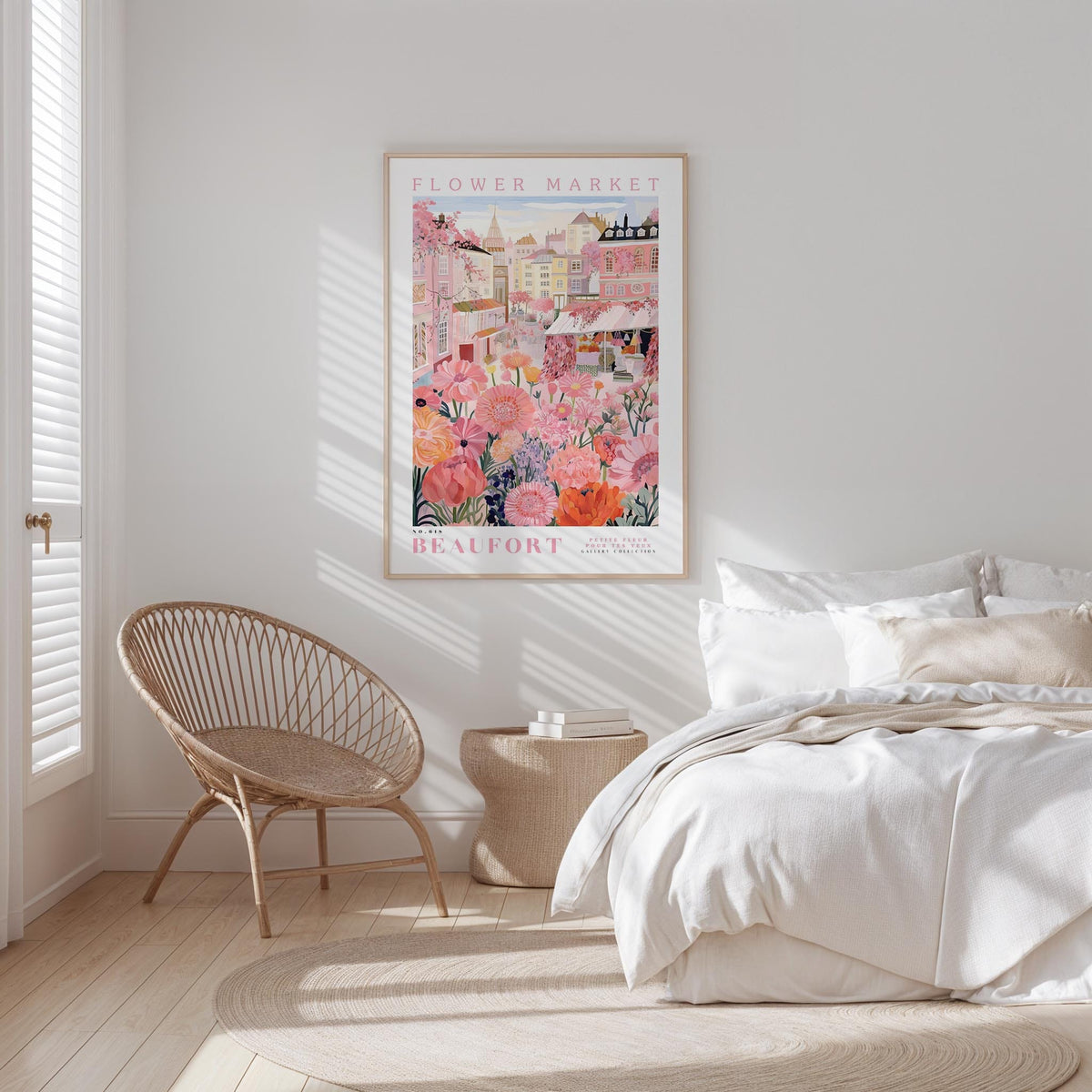a bedroom with a large floral poster hanging on the wall, a woven chair, and a bed with white bedding.