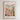 The image is a framed poster depicting a vibrant and colorful cityscape with a variety of flowers and plants in the foreground.