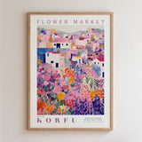 The image is a framed poster depicting a colorful, vibrant flower market scene with various flowers and buildings.