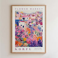 The image is a framed poster depicting a colorful, vibrant flower market scene with various flowers and buildings.