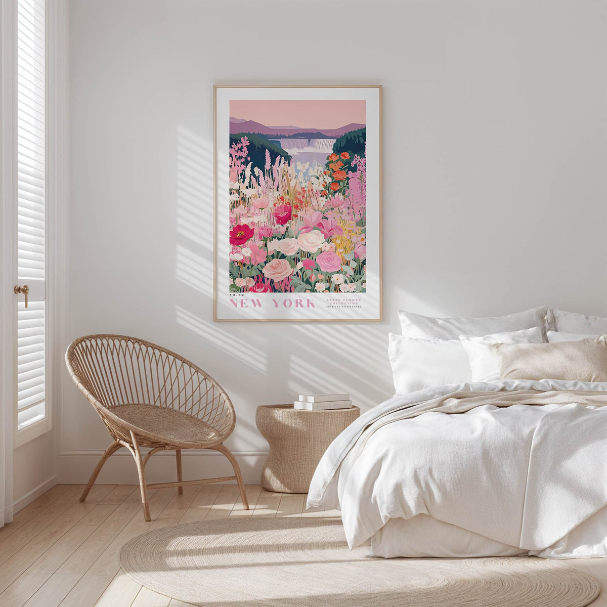 a serene bedroom scene with a large floral print hanging on the wall, a woven chair, a white bed with a beige blanket, and a wooden nightstand with a lamp.