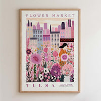 The image is a framed poster depicting a cityscape with a flower market in the background.