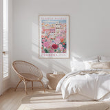 a bedroom with a bed, a woven chair, and a framed poster of a flower market in Cordoba, Spain.