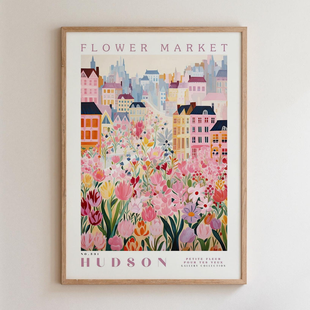A framed poster depicting a vibrant and colorful cityscape with a variety of flowers and buildings, including a prominent pink flower in the foreground.