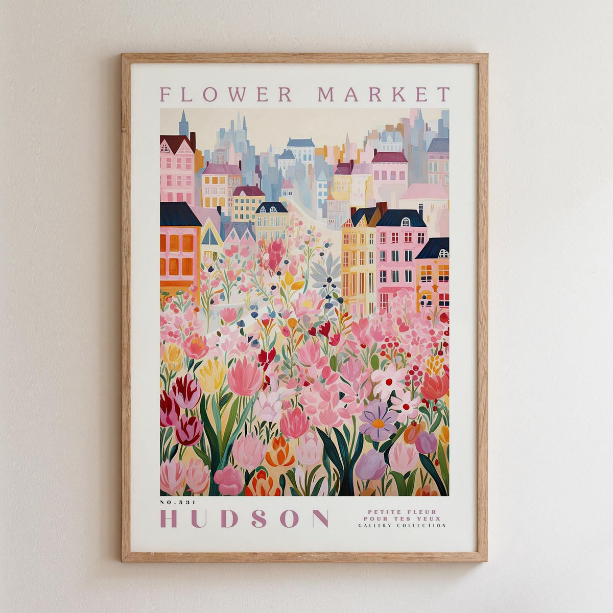 A framed poster depicting a vibrant and colorful cityscape with a variety of flowers and buildings, including a prominent pink flower in the foreground.