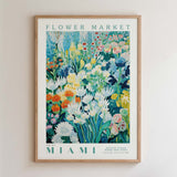 The image is a framed poster depicting a vibrant and colorful flower market scene in Miami.