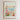 The image is a framed poster depicting a cityscape with a flower market in the foreground.
