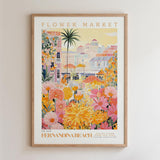 The image is a framed poster depicting a vibrant and colorful flower market in Fennandina Beach, with a variety of flowers and buildings in the background.