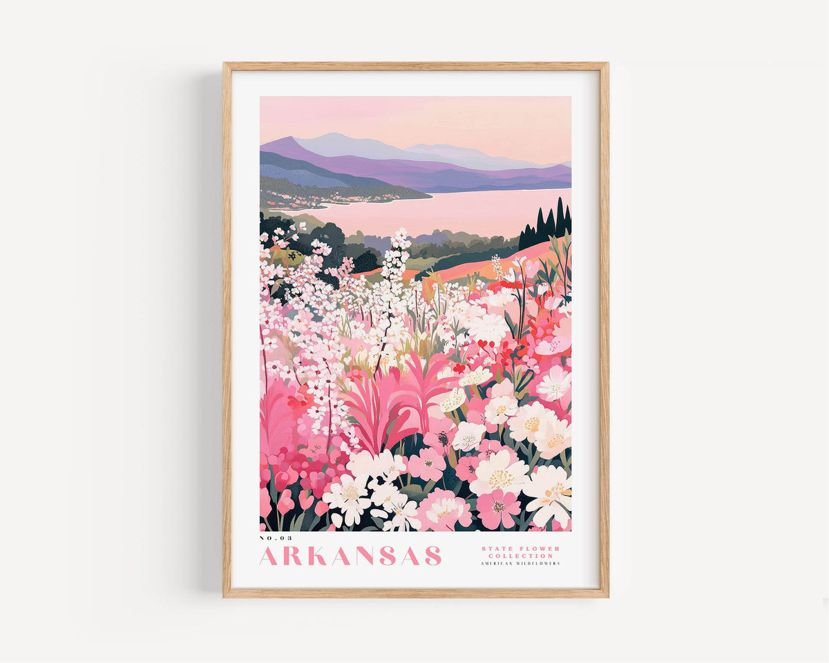 A framed poster depicting a scenic landscape with mountains, a lake, and a field of colorful flowers, including pink, white, and purple blooms.