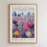 A framed poster depicting a vibrant flower market in Omaha, Nebraska, with a city skyline in the background.