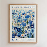 The image is a framed poster depicting a vibrant and colorful floral scene, with various types of flowers and plants arranged in a visually appealing manner.