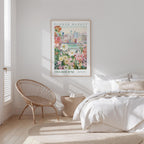 a bedroom with a large poster of a cityscape hanging on the wall, a woven chair, and a bed with white bedding.