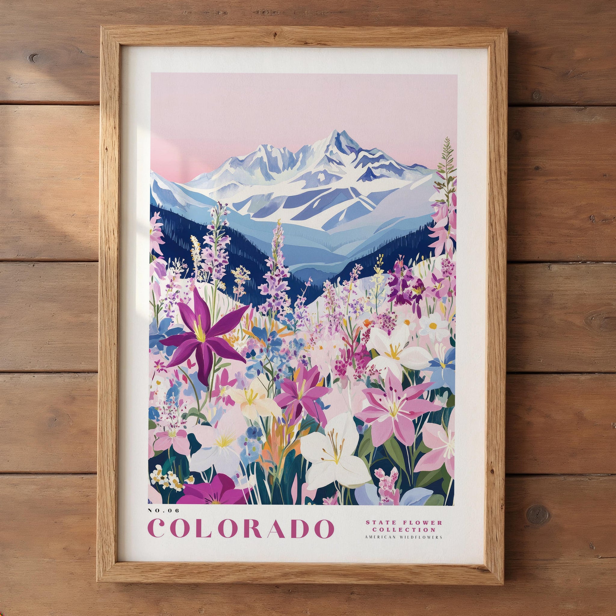 A framed poster depicting a scenic landscape with a mountain range in the background and a field of colorful wildflowers in the foreground.