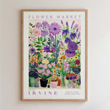 The image is a framed poster depicting a vibrant and colorful flower market.