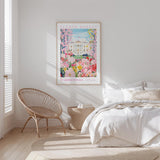 a bedroom with a bed, a woven chair, and a framed poster of a flower market in Washington, D.C.