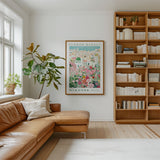 a cozy living room with a large window, a comfortable leather couch, a bookshelf filled with books, and a framed poster of a flower market in the background.