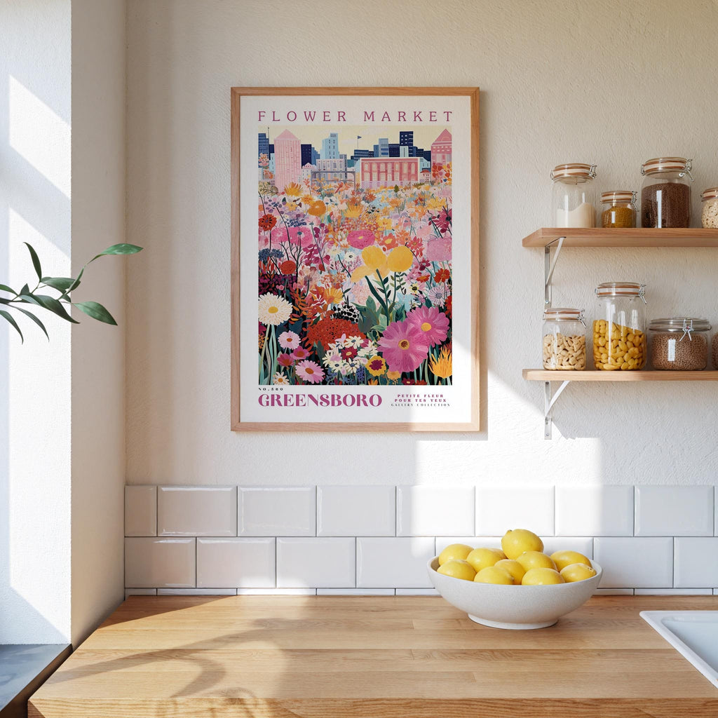 a kitchen counter with a bowl of lemons, a framed poster of a flower market, and shelves with jars and containers.