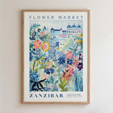 The image is a framed poster depicting a colorful and vibrant flower market in Zanzibar, featuring a variety of flowers and plants.