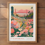 A framed poster depicting a vibrant field of flowers with a red suspension bridge in the background, set against a sunset sky.
