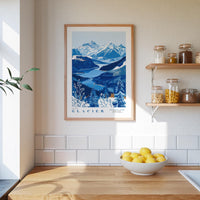 a framed poster of a mountainous landscape with a blue and white color scheme, hanging on a wall above a wooden countertop with a bowl of lemons.