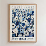 The image is a framed poster depicting a cityscape with a large field of flowers in the foreground.