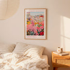 a bedroom with a bed, a nightstand, and a framed poster of a flower market in Nashville hanging on the wall.
