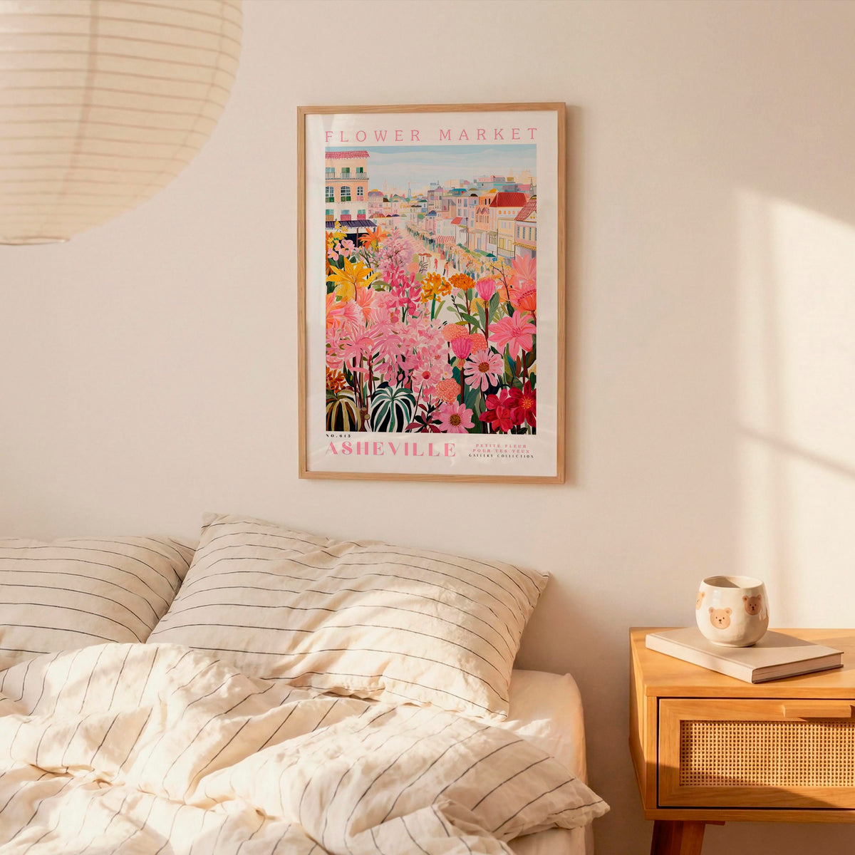 a bedroom with a bed, a nightstand, and a framed poster of a flower market in Nashville hanging on the wall.