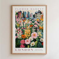 The image is a framed poster depicting a vibrant and colorful flower market in London.