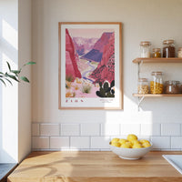 a kitchen counter with a bowl of lemons, a framed poster of a desert landscape, and a shelf with jars and bottles.