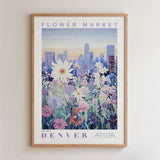 The image is a framed poster depicting a cityscape with a field of colorful flowers in the foreground.