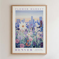 The image is a framed poster depicting a cityscape with a field of colorful flowers in the foreground.