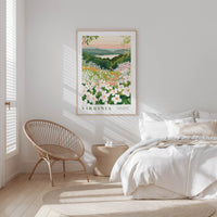 a serene bedroom scene with a bed, a woven chair, and a framed poster of a floral landscape hanging on the wall.