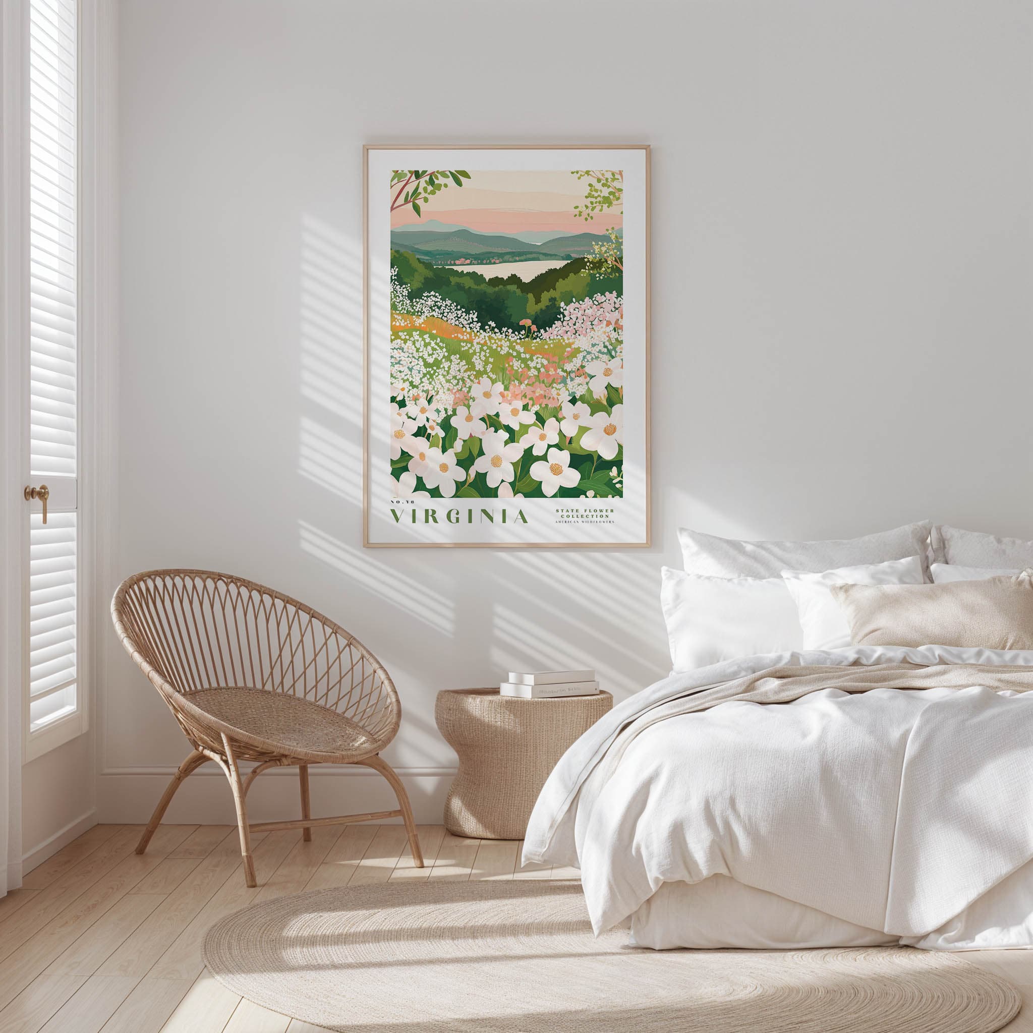 a serene bedroom scene with a bed, a woven chair, and a framed poster of a floral landscape hanging on the wall.