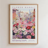 The image is a framed poster depicting a vibrant and colorful flower market in Stockton, with a variety of flowers and plants in full bloom.