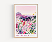 A framed illustration depicting a vibrant, colorful landscape with a variety of flowers and plants, set against a backdrop of mountains and a pink sky.