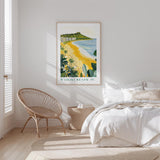 a serene bedroom scene with a large poster of Waikiki Beach hanging on the wall, a wicker chair, and a white bed with a beige blanket.